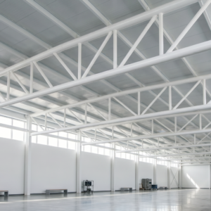 An industrial white building that's painted with a Intumescent coating on the exposed structural steel, for fireproofing.