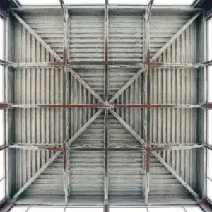 K-13 maintenance: exposed steel deck ceiling coated in gray-white spray-applied fiber insulation viewed from below